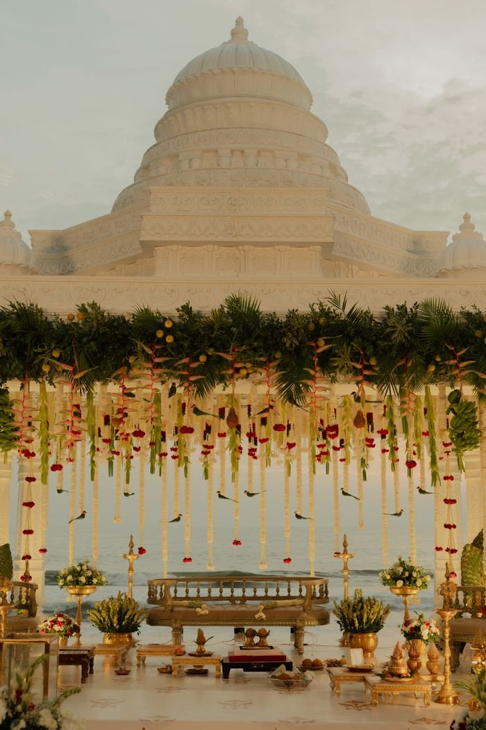 About Beautifully decorated Indian wedding mandap with floral arrangements and traditional elements.